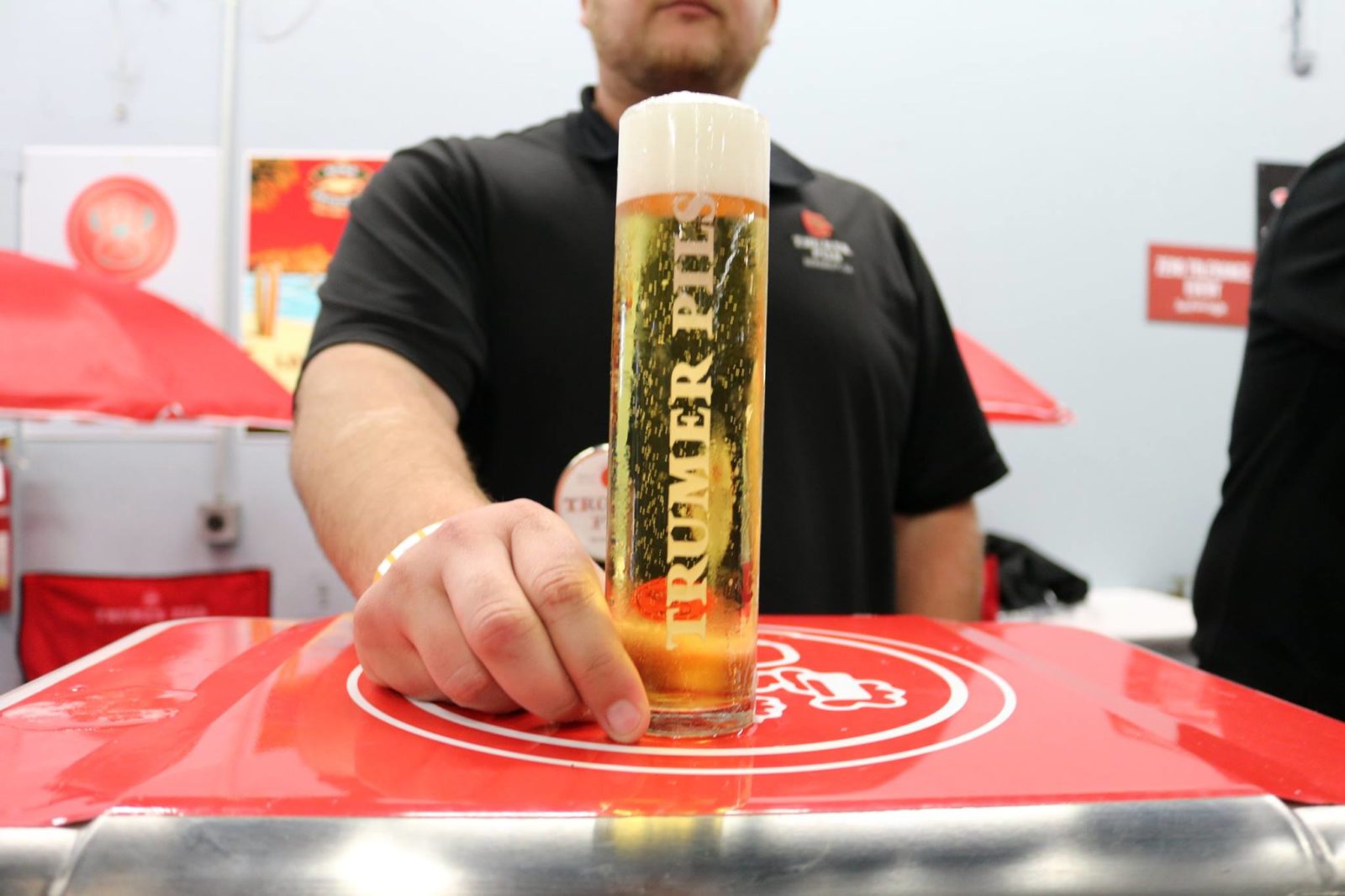 Man holding Trumer Pils glass